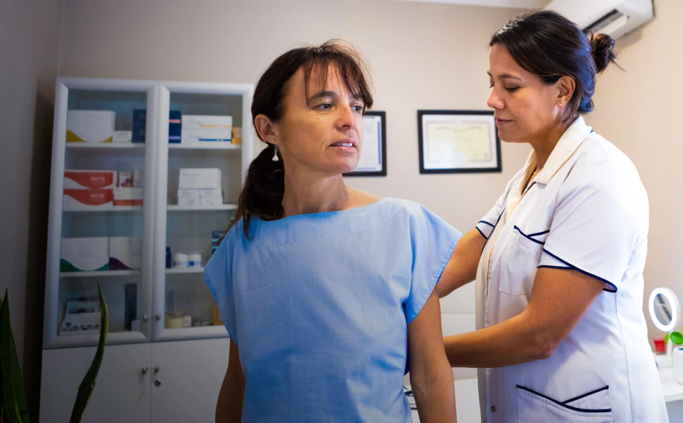 A nurse tends to a patient.