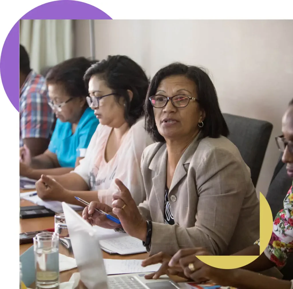 A group in a meeting at a table.