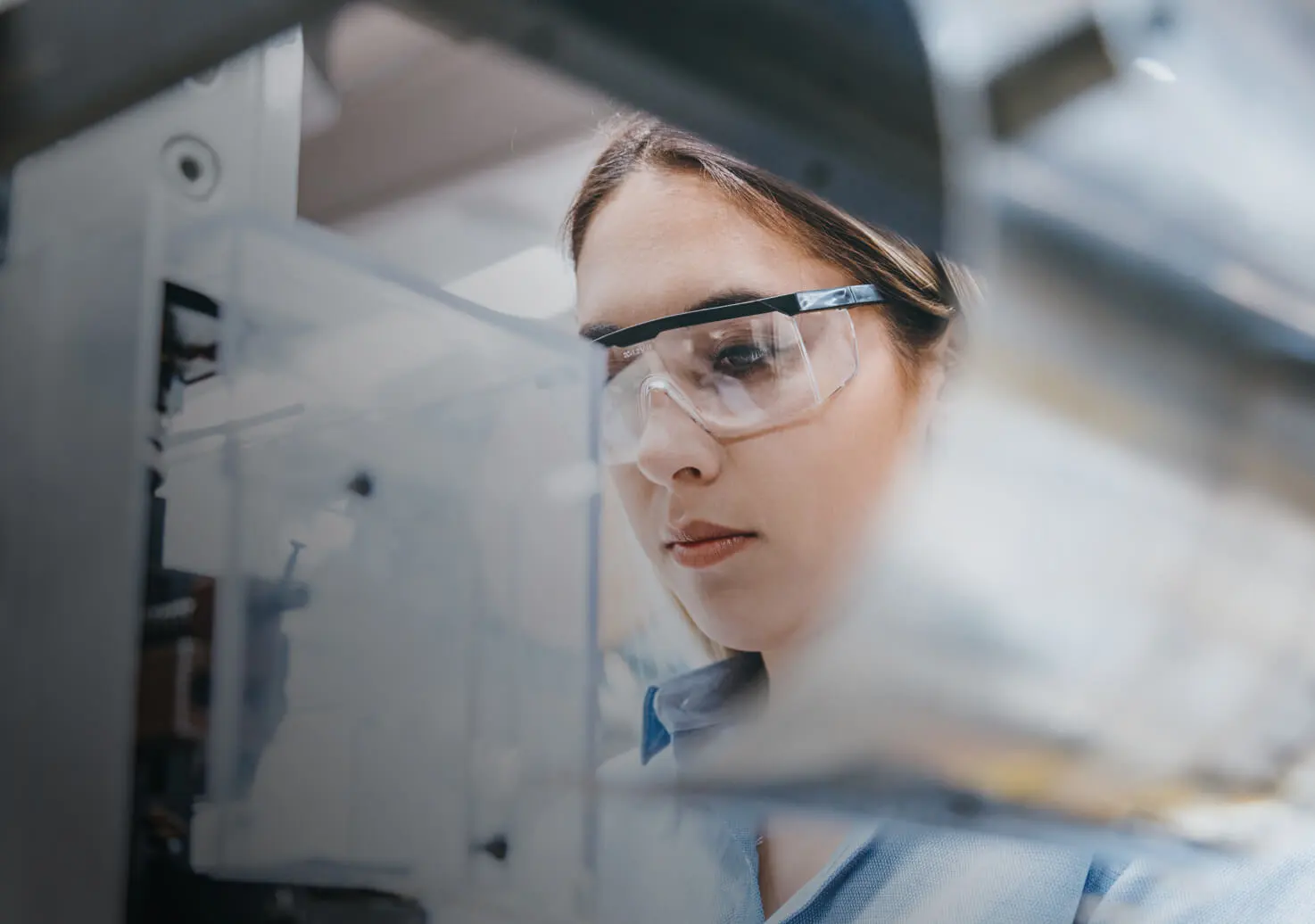 A woman with lab googles works.